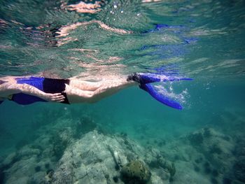 Side view of woman snorkeling undersea