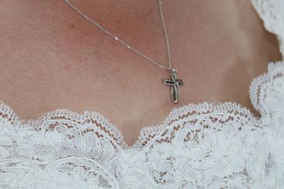 Close-up of woman wearing cross pendant