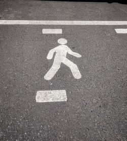 High angle view of person walking  sign on road