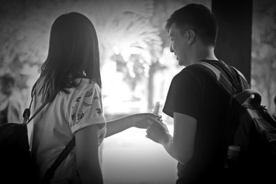 Side view of two women standing against blurred background