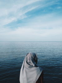 Woman standing against sea