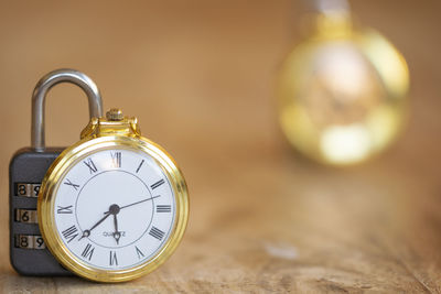 Close-up of pocket watch on table