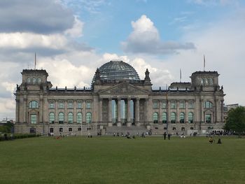 Tourist visiting the reichstag against sky