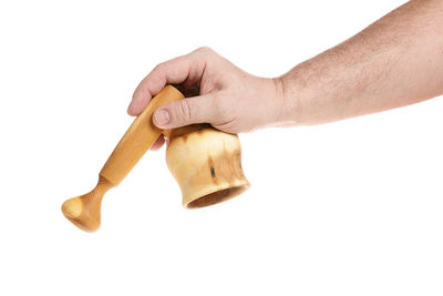 Close-up of hand holding bread against white background