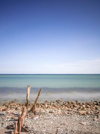 Scenic view of sea against clear blue sky