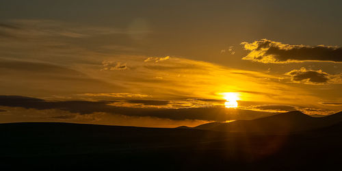 Scenic view of silhouette landscape against sky during sunset