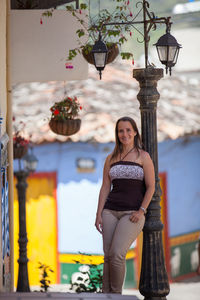 Young tourist woman at the colorful streets of guatape town in the region of antioquia in colombia