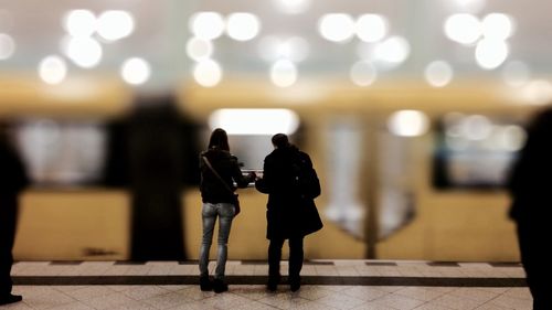 Woman standing in illuminated city at night