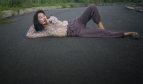 Woman lying on the road