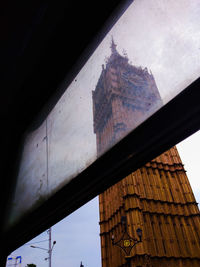 Low angle view of building seen through window