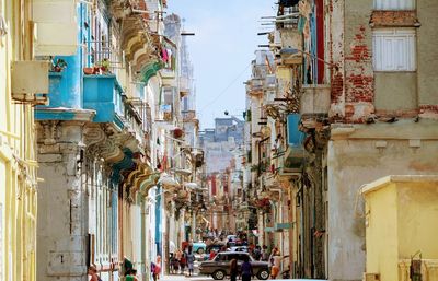People on street amidst buildings in city
