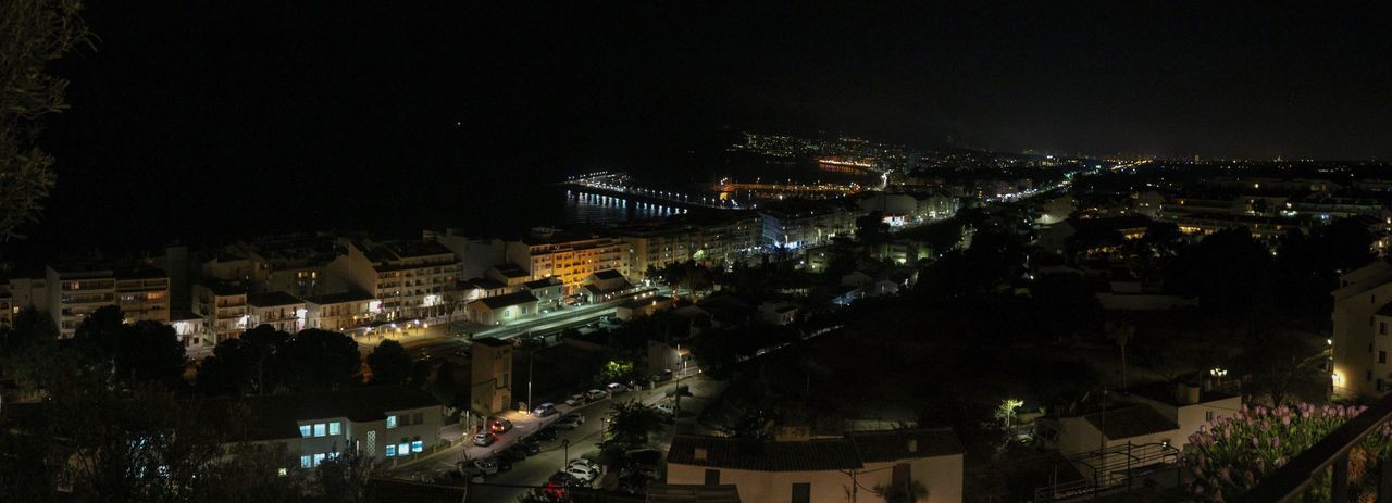 HIGH ANGLE VIEW OF ILLUMINATED BUILDINGS IN CITY