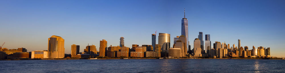 Modern buildings in city against clear sky