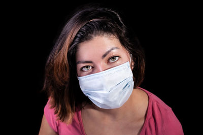 Portrait of a beautiful woman over black background