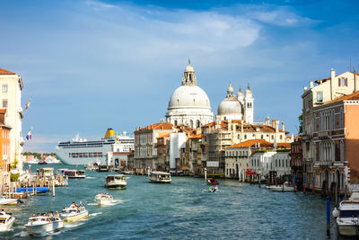 Santa maria della salute by canal against cloudy sky