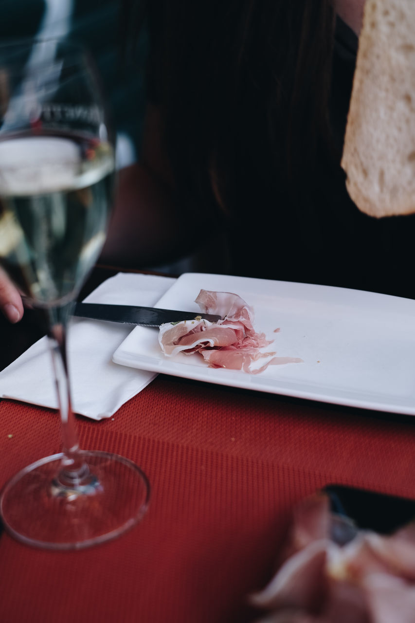 food and drink, table, plate, glass, business, drink, restaurant, refreshment, selective focus, indoors, freshness, food, eating utensil, drinking glass, wineglass, household equipment, kitchen utensil, still life, fork, close-up, no people, setting, table knife, crockery, red wine