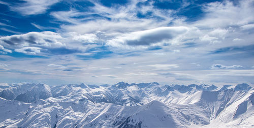 Scenic view of snowcapped mountains against sky