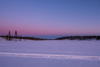 Scenic view of snow covered field against clear sky