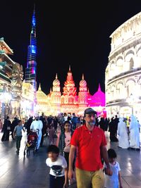 Group of people in front of building at night