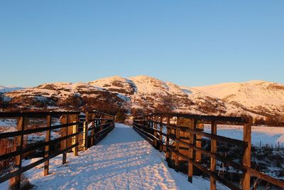 Snow covered mountain against clear blue sky