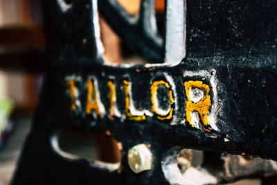 Close-up of text on rusty metal