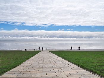 People on beach against sky