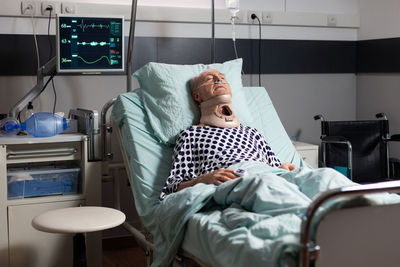 Midsection of man lying on bed