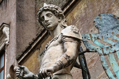 Low angle view of statue against building