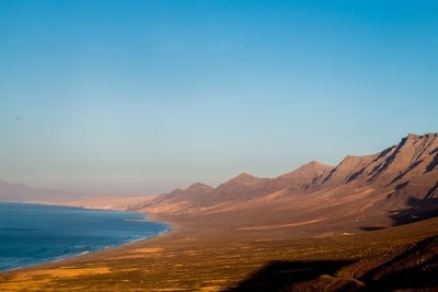 Scenic view of sea against clear sky during sunset