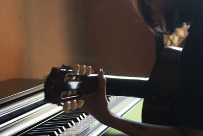 Close-up of girl playing guitar 