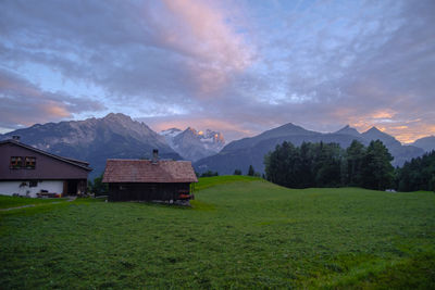 Scenic view of field and mountains against sky