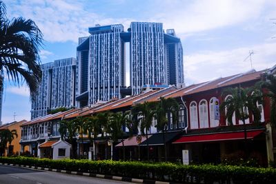 Low angle view of buildings against cloudy sky