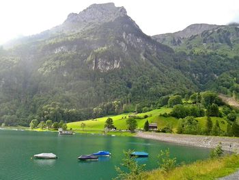 Scenic view of river with mountains in background