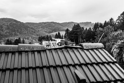 Roof of building and mountains against sky