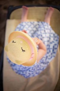 Close-up of woman holding hat