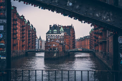 Bridge over canal amidst buildings in city