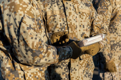 Low section of soldiers holding book