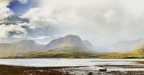 Scenic view of lake and mountains against sky