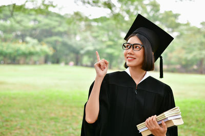 Portrait of beautiful young woman holding camera