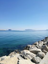 Scenic view of sea against clear blue sky