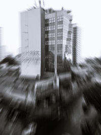 Blurred motion of modern buildings against clear sky