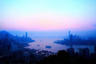 City at waterfront during sunset