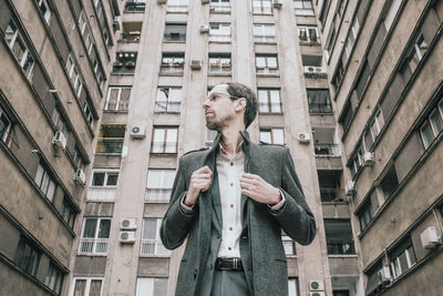 Full length of young man standing in city