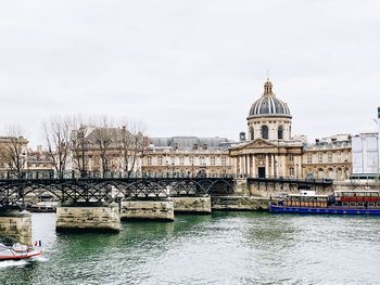 Bridge over river with buildings in background