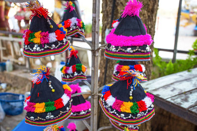 Close-up of multi colored hats for sale at market stall