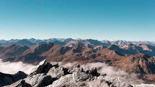 Scenic view of mountains against clear blue sky