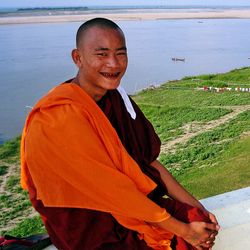 Portrait of smiling man sitting on land