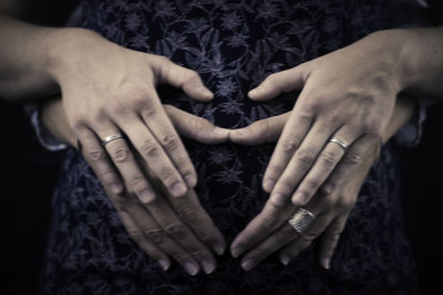 Close-up of hands touching woman