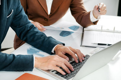 Low section of people working on table