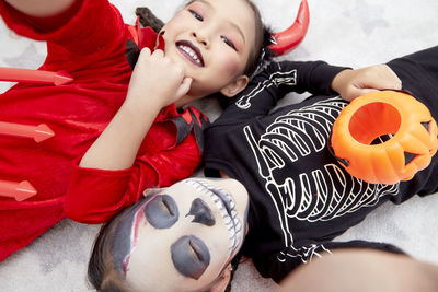 High angle view of smiling boy lying on toy